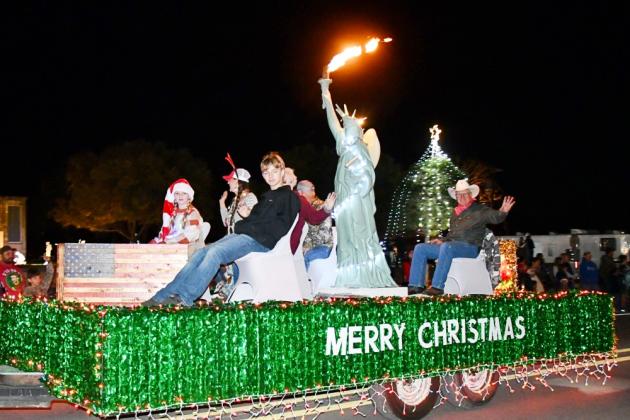 A patriotic float with Miss Liberty in the Christmas Parade.