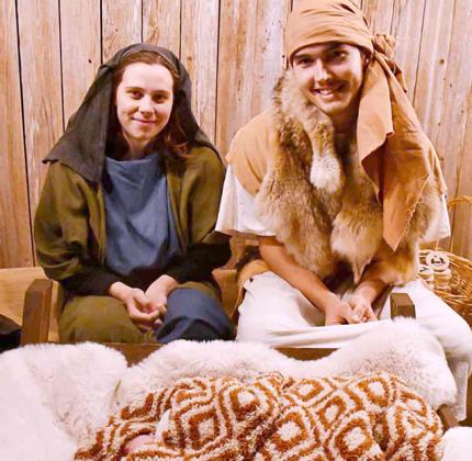 Jaslyn and Troy Klaassen with Avelyn Klaassen re-enact the Christmas story at the Bethlehem Under the Stars. BULLETIN PHOTO/Tracy Thayer