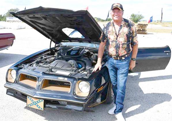 Former County Commissioner Doug King brought four classic cars to the American Legion Auxiliary Car Show. Here, he is shown with his rare 1976 T-Top Trans Am. BULLETIN PHOTO/Tracy Thayer