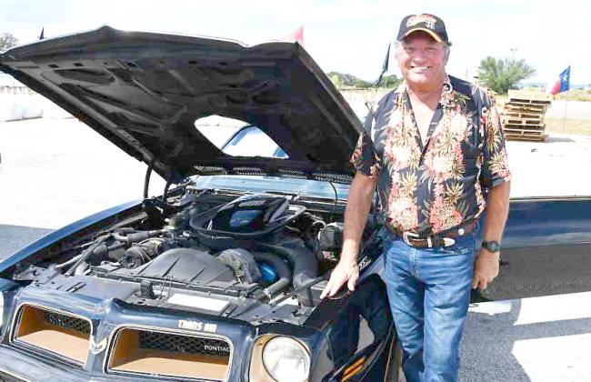 Former County Commissioner Doug King brought four classic cars to the American Legion Auxiliary Car Show. Here, he is shown with his rare 1976 T-Top Trans Am. BULLETIN PHOTO/Tracy Thayer