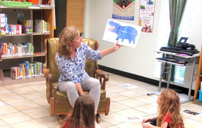Medina Community Library Director Alison Harbour runs the weekly Little One Story Time event last Wednesday, September 22, with a group of moms and young children learning and having fun. BULLETIN PHOTO/Chuck McCollough