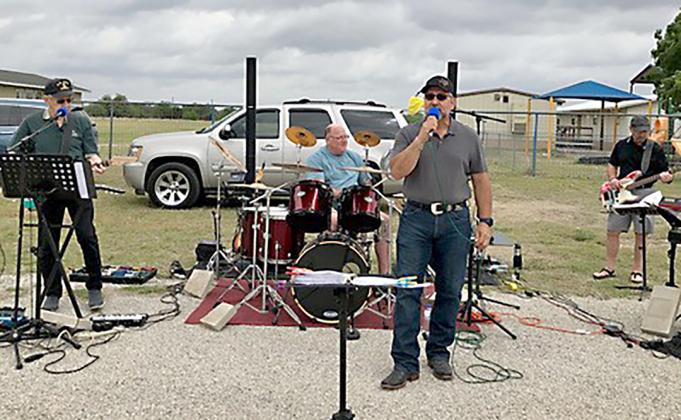 Randall Duncan, lead singer of Cross Hill Junction Band, keeps attendees entertained at Pipe Creek Christian school’s spring event earlier this month. BULLETIN PHOTO/Vicki L. George