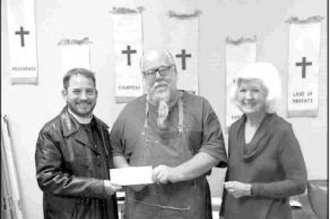 COURTESY PHOTO                      The Rev. Rob Harris with St. Christopher’s Episcopal Church, left, and Silver Sage Executive Director Art Crawford display a check for $300 that the church presented to the Silver Sage to help it operate the Meals