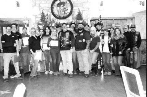 BULLETIN PHOTO/Bill Pack                      Jeff “Shooter” Butz, commander of the Alamo Chapter of the Combat Veterans Motorcycle Association, ninth from left, and other members of the chapter, pose with Cindy Stevens, seventh from left, the exe