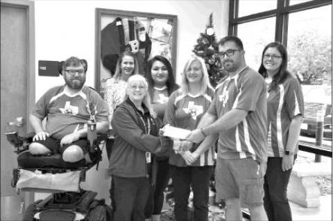 COURTESY PHOTO                      Jeremiah “JT” Trombly, operations manager for the Bandera Youth Soccer Organization, second from right, makes a donation of more than $2,650 to Bandera Independent School District Food Services Administrative As