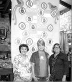 BULLETIN PHOTO/Bill Pack                      Tarpley quilter Mel Dugosh, center, stands in front of a quilt she hand made in honor of her sister-in-law Elenora Dugosh Goodley, left, who has donated the quilt to the Frontier Times Museum in Bandera fo