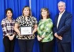 Board President Brittany Hicks with BISD Staff Member of the Month JoAnn Briones-Amador, Principal Dixie Moseley and Superintendent Gary Bitzkie.