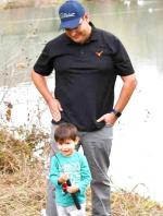Bennie Alcorta shows his very first catch, a small trout! Dad Jacob looks on proudly. They participated in the Fish for Fun event at River Park on Monday, December 13. BULLEIN PHOTO/Tracy Thayer