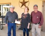 Bandera County Farm Bureau President Booker Young (left) and Vice President Robert Mazurek (right) present a donation to Jessie Parks of Helping Hand in honor of Texas Food Connection Day, which will officially be celebrated on March 14. Courtesy Photo