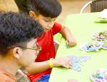 Nathaniel Sanchez (top) and Bryan Villaneda (bottom) from San Antonio work on their butterfly craft project at the Bandera Museum of Natural History. BULLETIN PHOTO/Tracy Thayer