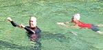 Heidi and Travis Klassen swim in the Medina River during the third annual winter swim. Heidi, who organizes the event, was donned in a shark swimming cap to fend off any vicious creatures swimming in the waters. Courtesy Photo