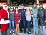 From left, Santa, Alana Smith, Alisha Lee, Jody Miller, Marian Ernest, Alex Bible and Doug Tharp all were full of the holiday spirit during the Shotgun Sports Bar and Grill’s Angel Tree pick up on Tuesday afternoon at the Bandera Fire Station. BULLETIN 